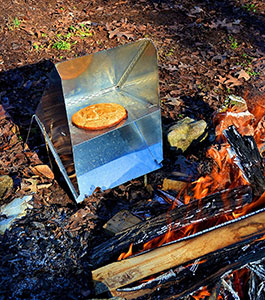 Bannock cooking in a reflector oven.